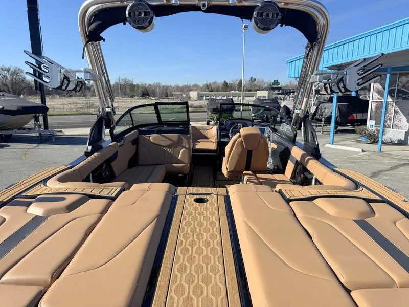 Slide: The Image of 2022 MasterCraft XT23 boat interior with tan seating and modern design features. - 8