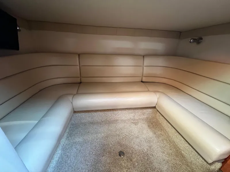 Slide: The Image of 2007 Larson Cabrio 350 interior with beige leather seating and carpeted floor. - 13