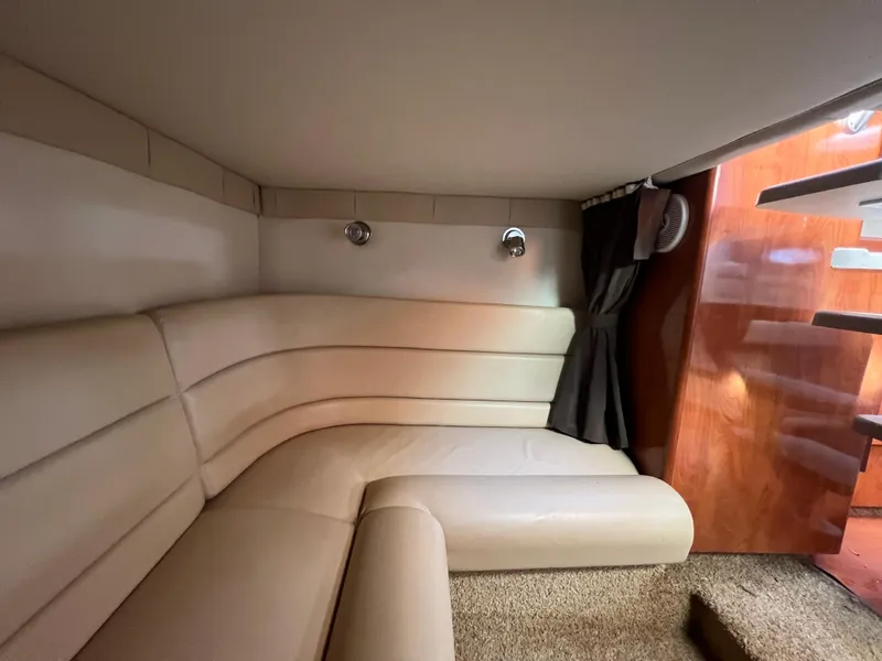 Slide: The Image of 2007 Larson Cabrio 350 interior with beige leather seating and wooden accents. - 15