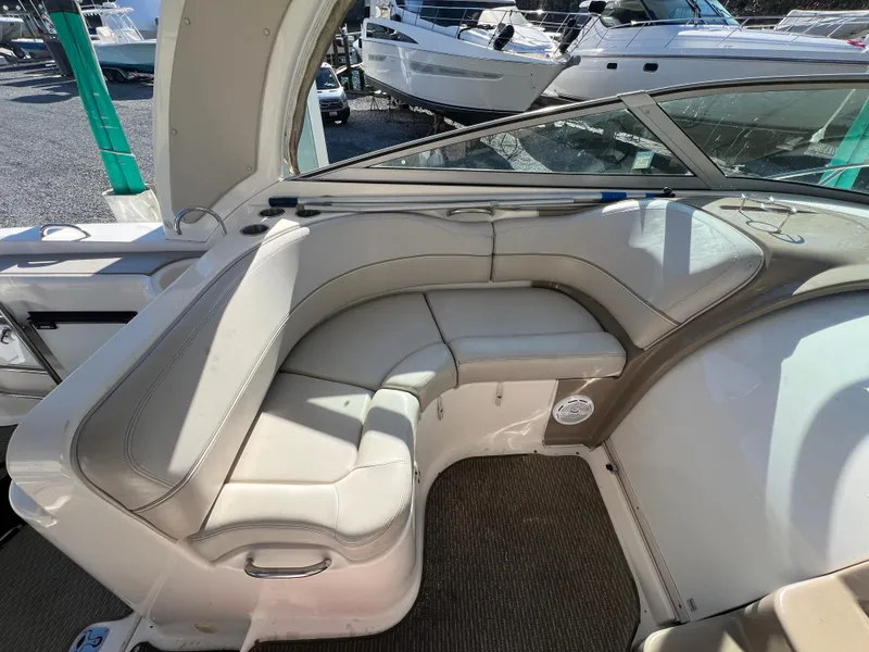 Slide: The Image of 2007 Larson Cabrio 350 boat interior with beige seating and carpeted floor. - 4