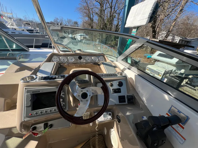 Slide: The Image of 2007 Larson Cabrio 350 boat cockpit with steering wheel and control panel. - 6