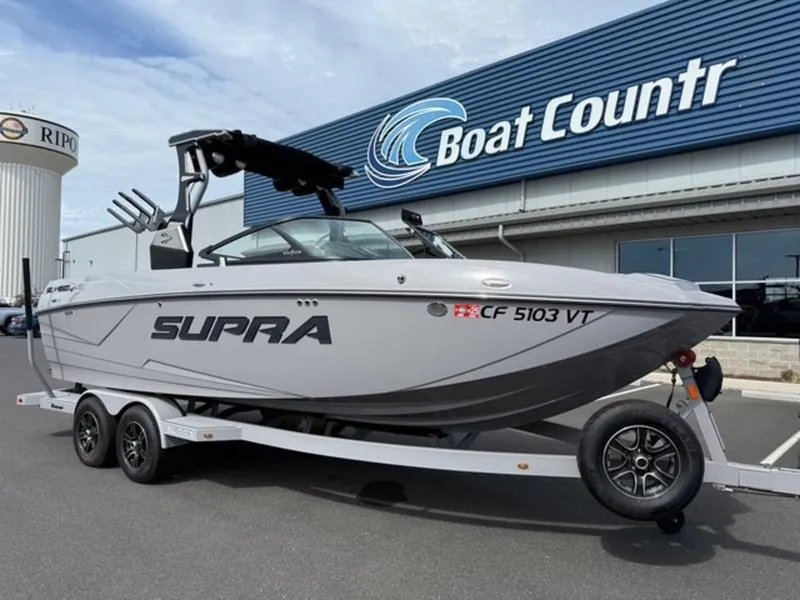 Slide: The Image of 2020 Supra SL450 boat on trailer at Boat Country dealership. - 0
