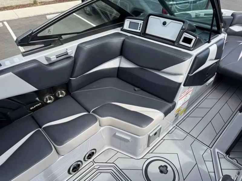Slide: The Image of 2020 Supra SL450 boat interior with gray and white seating, modern dashboard, and sleek design. - 12
