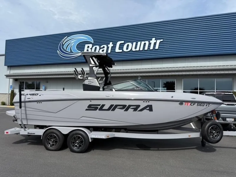 Slide: The Image of 2020 Supra SL450 boat on trailer outside Boat Country dealership. - 15