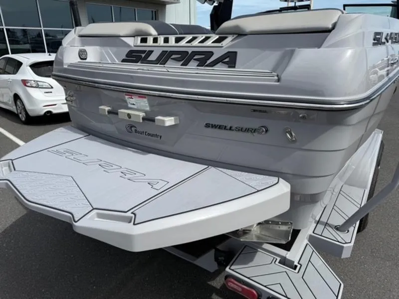 Slide: The Image of 2020 Supra SL450 boat rear view with Swell Surf system and branded platform. - 5