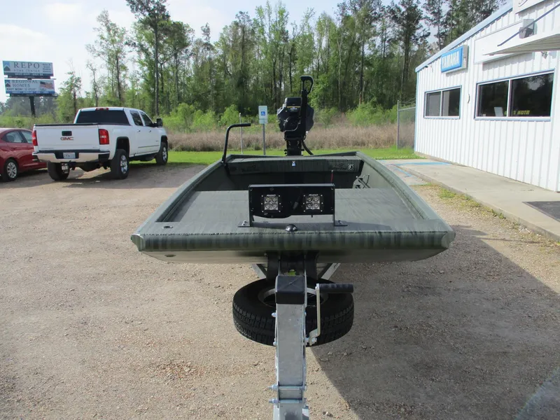 Slide: The Image of 2025 Gator Tail 1754 Extreme boat on trailer, parked outdoors near dealership. - 2