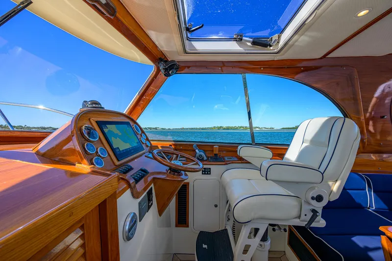 Slide: The Image of Helm of 2010 Hinckley Picnic Boat 37 MKIII with luxurious seating and navigation controls. - 13