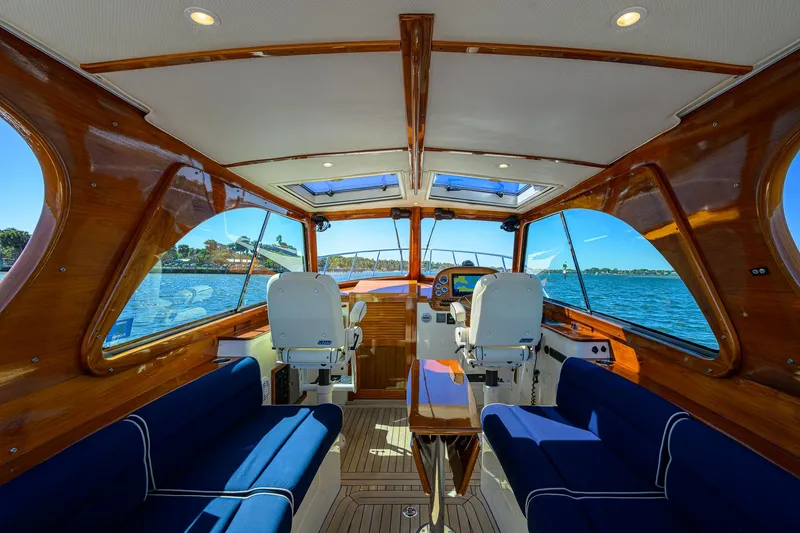 Slide: The Image of Interior of 2010 Hinckley Picnic Boat 37 MKIII with luxurious seating and wooden finishes. - 16