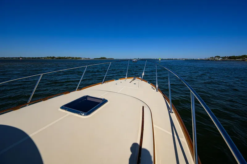 Slide: The Image of 2010 Hinckley Picnic Boat 37 MKIII cruising on open water under clear blue skies. - 25