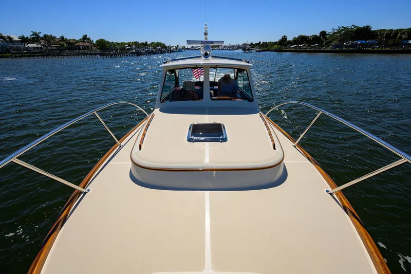Slide: The Image of 2010 Hinckley Picnic Boat 37 MKIII cruising on a sunny day, showcasing elegant design. - 27