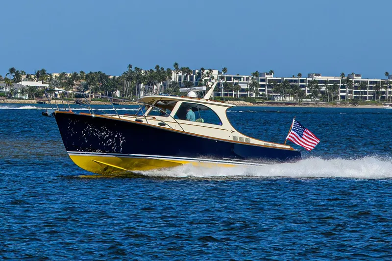 Slide: The Image of 2010 Hinckley Picnic Boat 37 MKIII cruising on blue water with American flag. - 3