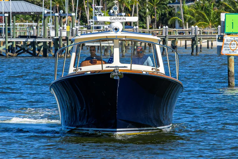 Slide: The Image of 2010 Hinckley Picnic Boat 37 MKIII cruising on a sunny day near a dock. - 4