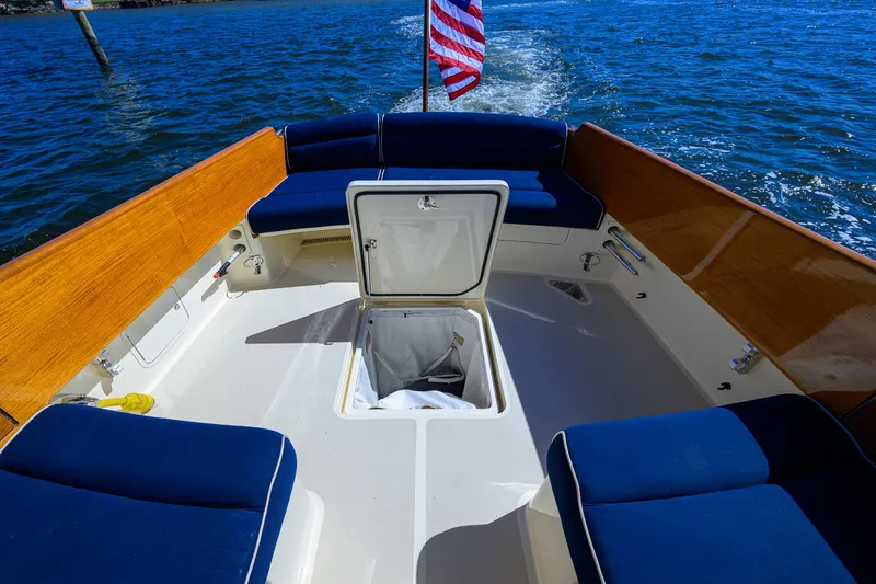 Slide: The Image of Hinckley Picnic Boat 37 MKIII, 2010 model, open deck with seating and storage, on water. - 6