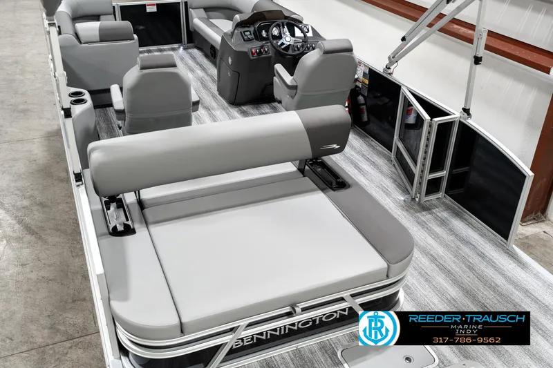 Slide: The Image of 2025 Bennington 21 SSB pontoon boat interior with gray seating and modern dashboard. - 12