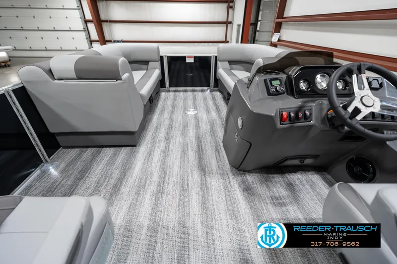 Slide: The Image of 2025 Bennington 21 SSB pontoon boat interior with modern seating and steering console. - 17