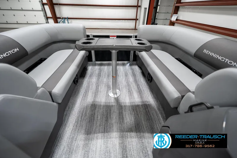 Slide: The Image of 2025 Bennington 21 SSB boat interior with gray seating and central table. - 20