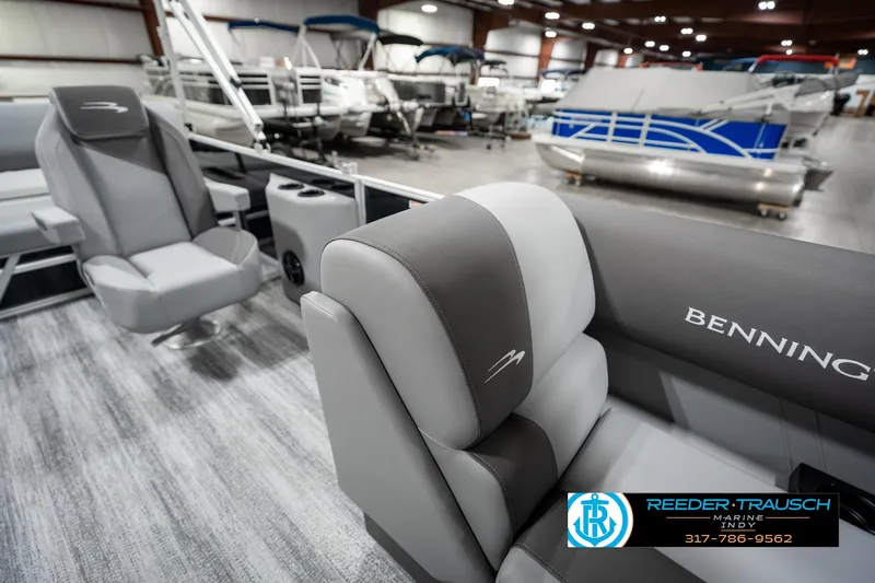 Slide: The Image of 2025 Bennington 21 SSB boat interior with gray seating in showroom. - 21