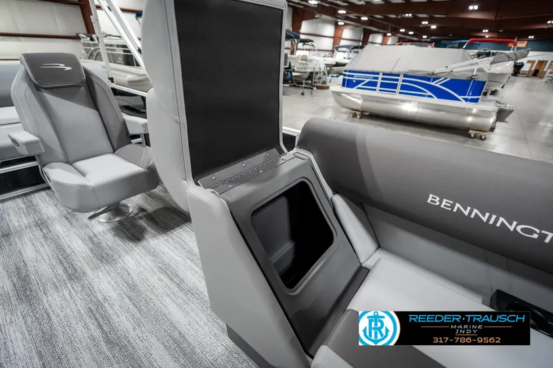 Slide: The Image of 2025 Bennington 21 SSB boat interior with gray seating and storage compartment. - 22