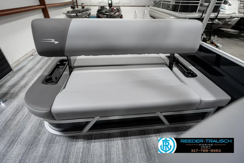 Slide: The Image of 2025 Bennington 21 SSB boat seat in showroom, featuring gray upholstery and sleek design. - 23