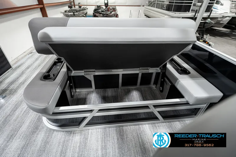 Slide: The Image of 2025 Bennington 21 SSB boat interior with gray seating and storage compartment. - 25