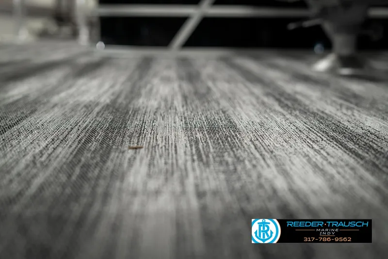 Slide: The Image of 2025 Bennington 21 SSB boat flooring, textured surface, Reeder-Trausch Marine logo visible. - 45