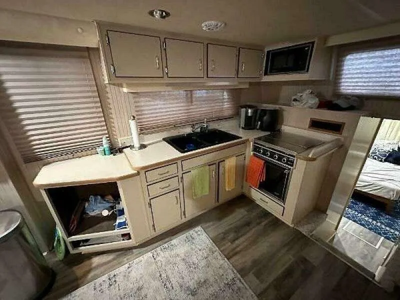 Slide: The Image of 2004 Gibson 50 Houseboat kitchen with modern appliances and ample storage space. - 10