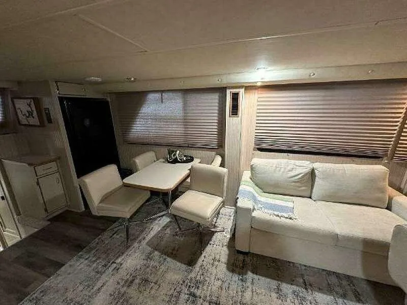 Slide: The Image of Interior of 2004 Gibson 50 Houseboat with sofa, dining table, and chairs. - 11