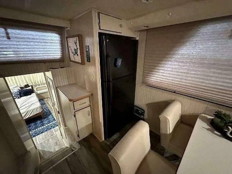 Slide: The Image of Interior of a 2004 Gibson 50 Houseboat with kitchen and dining area. - 12