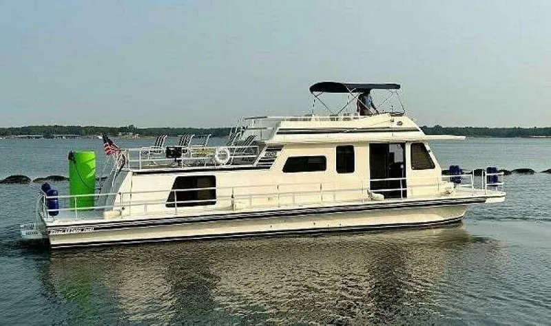 Slide: The Image of 2004 Gibson 50 Houseboat cruising on calm waters with upper deck seating. - 20