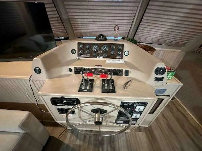 Slide: The Image of 2004 Gibson 50 Houseboat helm with steering wheel and control panel. - 6