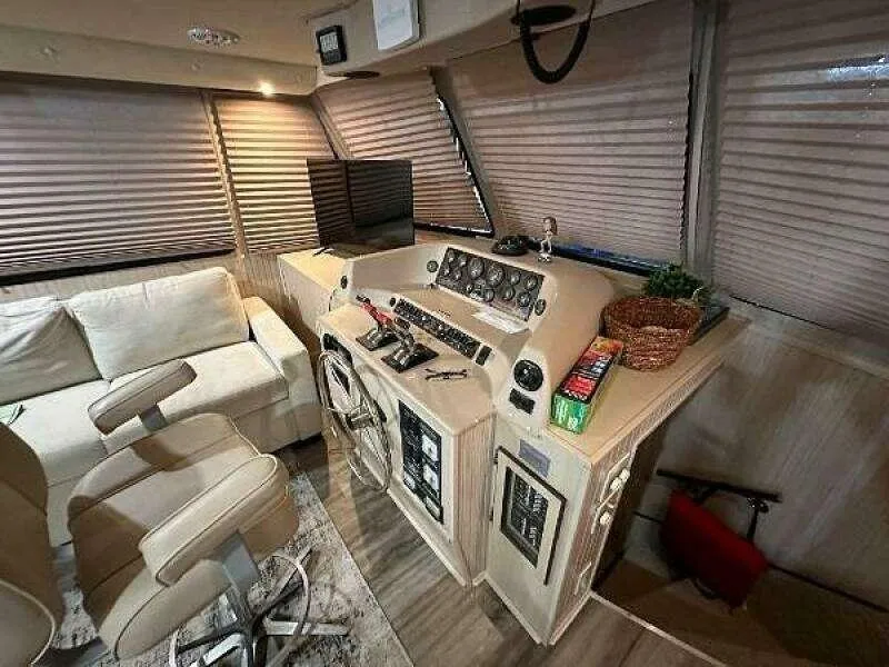 Slide: The Image of 2004 Gibson 50 Houseboat interior with helm, seating, and modern controls. - 7