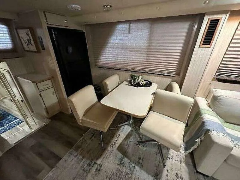 Slide: The Image of Interior of 2004 Gibson 50 Houseboat with dining area and modern furnishings. - 9