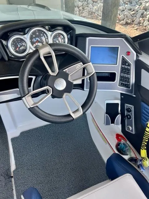 Slide: The Image of 2019 MasterCraft X22 boat dashboard with steering wheel and control panel. - 10