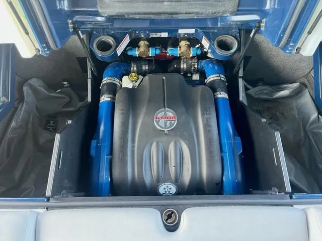 Slide: The Image of 2019 MasterCraft X22 engine compartment with Ilmor engine and blue hoses. - 11