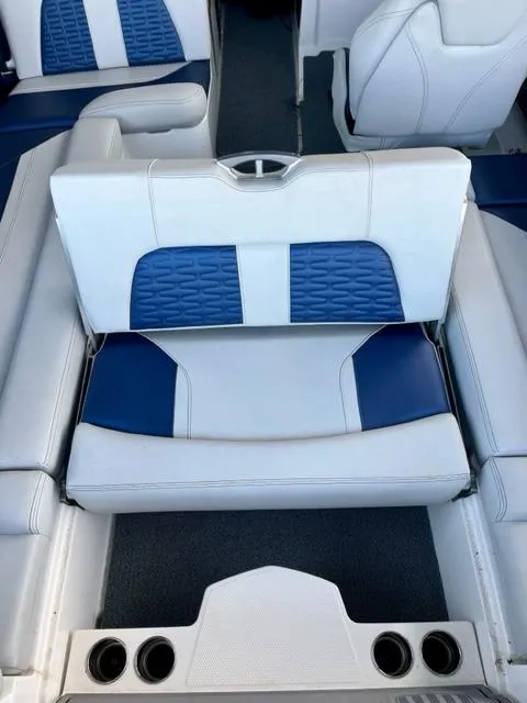 Slide: The Image of 2019 MasterCraft X22 boat interior with blue and white seating and cup holders. - 6