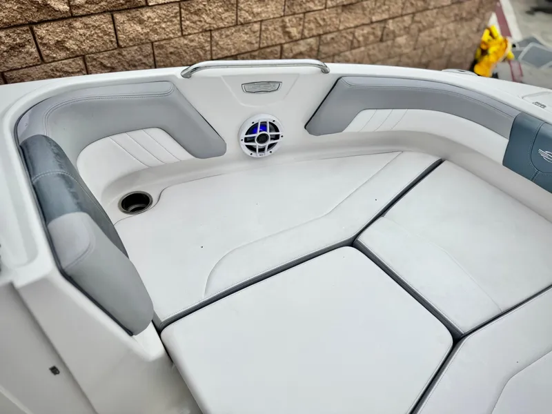 Slide: The Image of 2021 Chaparral 21 SSi boat interior with cushioned seating and speaker. - 13