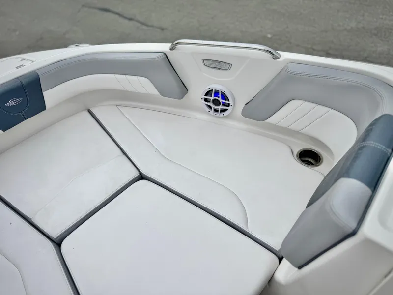 Slide: The Image of 2021 Chaparral 21 SSi boat interior with cushioned seating and speaker. - 14