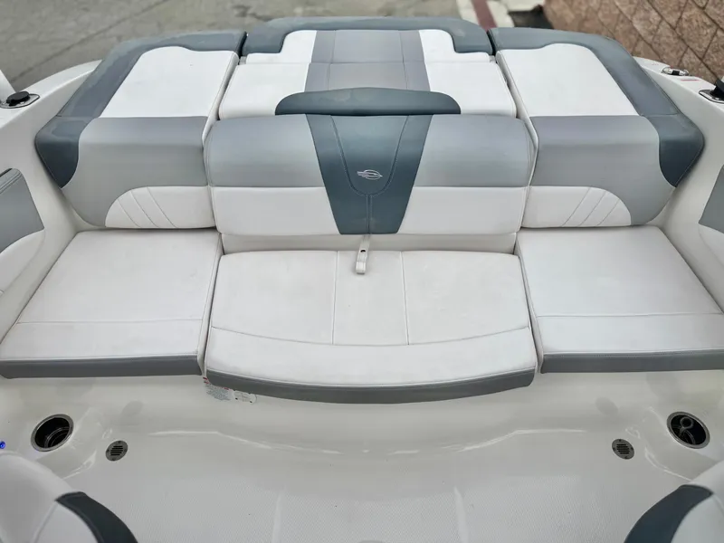 Slide: The Image of 2021 Chaparral 21 SSi boat interior with gray and white cushioned seating. - 18