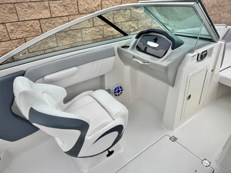 Slide: The Image of 2021 Chaparral 21 SSi boat interior with helm, captain's chair, and dashboard. - 22