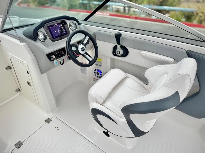 Slide: The Image of 2021 Chaparral 21 SSi boat interior with modern dashboard and comfortable seating. - 27