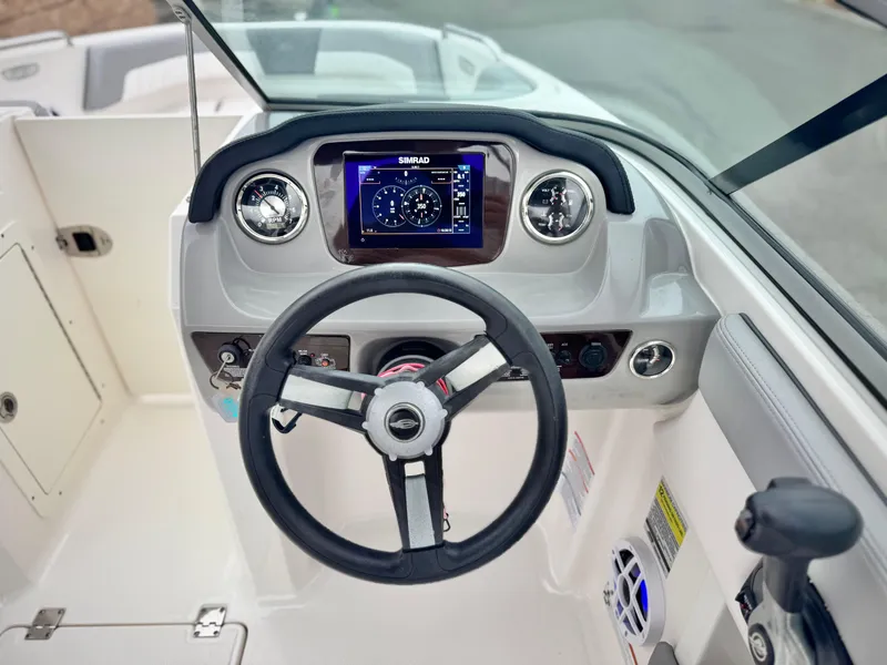 Slide: The Image of 2021 Chaparral 21 SSi boat dashboard with steering wheel and digital display. - 28