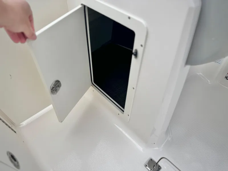 Slide: The Image of Open storage compartment on 2021 Chaparral 21 SSi boat, showcasing interior space. - 30
