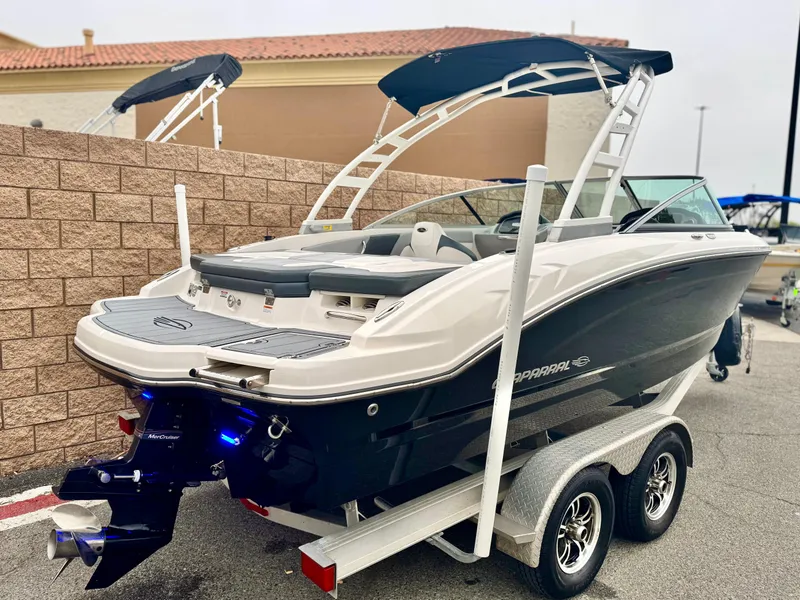 Slide: The Image of 2021 Chaparral 21 SSi boat on trailer, featuring sleek design and dual bimini tops. - 5
