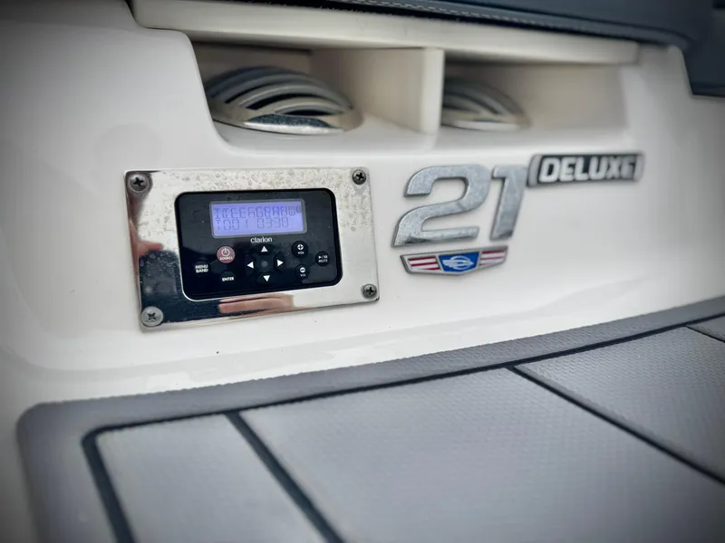Slide: The Image of 2021 Chaparral 21 SSi Deluxe boat dashboard with control panel and emblem. - 8