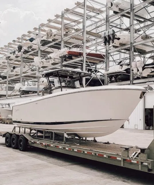 Slide: The Image of 2024 SeaWell 240CC boat on trailer in storage facility. - 14