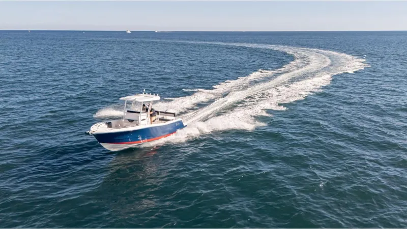 Slide: The Image of 2024 SeaWell 240CC boat cruising on open ocean, leaving a wake trail. - 16