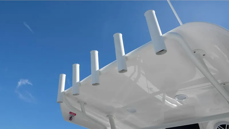 Slide: The Image of 2024 SeaWell 240CC boat roof with rod holders against clear blue sky. - 17