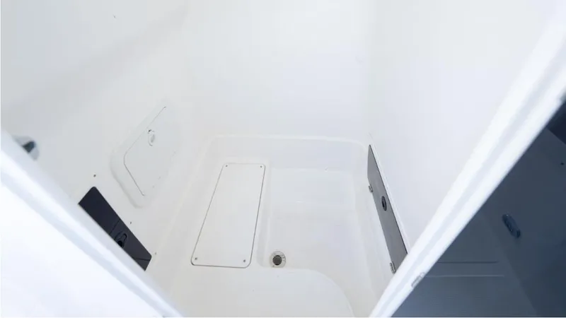 Slide: The Image of 2024 SeaWell 240CC boat interior compartment, featuring a clean, white design with storage access. - 28