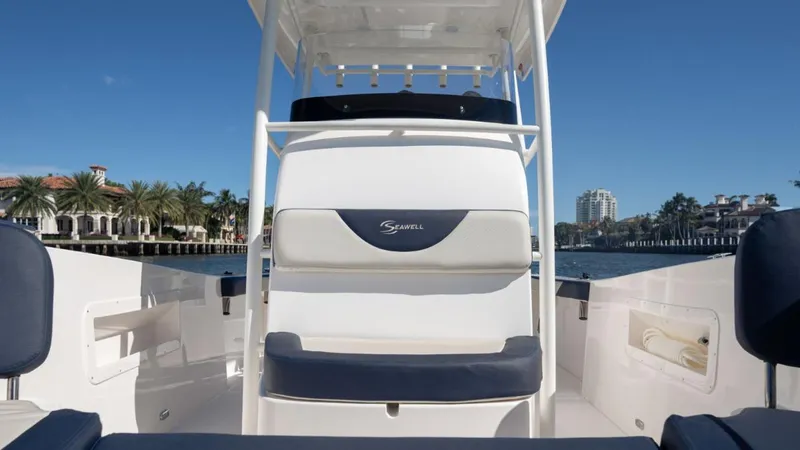 Slide: The Image of 2024 SeaWell 240CC boat interior with seating, set against a waterfront backdrop. - 29