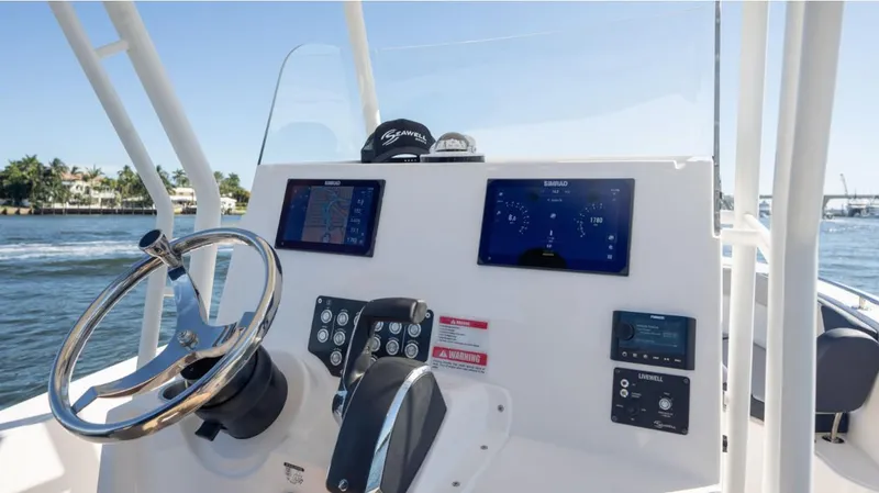 Slide: The Image of 2024 SeaWell 240CC boat dashboard with modern navigation displays and steering wheel. - 32